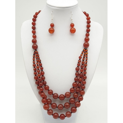 253 - A three row carnelian necklace and earrings set, in a presentation box. From ancient Egypt to presen... 