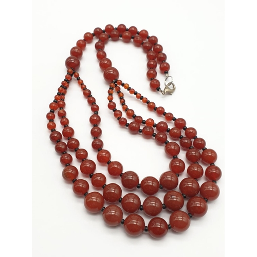 253 - A three row carnelian necklace and earrings set, in a presentation box. From ancient Egypt to presen... 