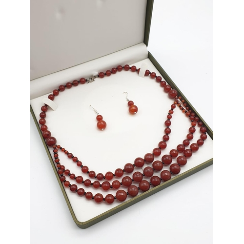 253 - A three row carnelian necklace and earrings set, in a presentation box. From ancient Egypt to presen... 