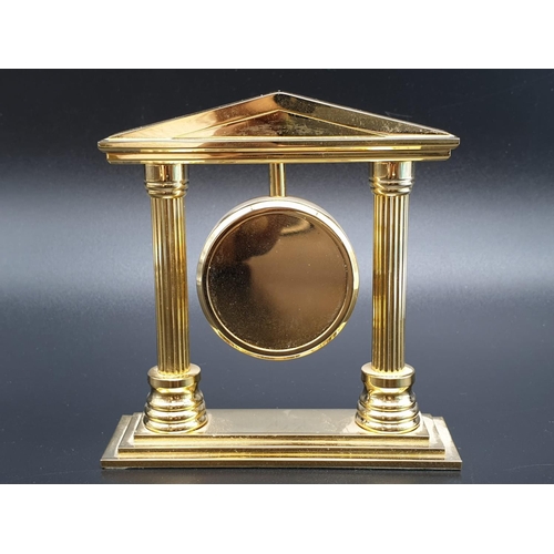 423 - A Bueche-Girod marked Gold-Tone Temple-Style Clock.
As found, 10x 10cm