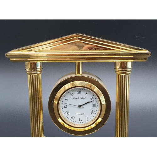 423 - A Bueche-Girod marked Gold-Tone Temple-Style Clock.
As found, 10x 10cm