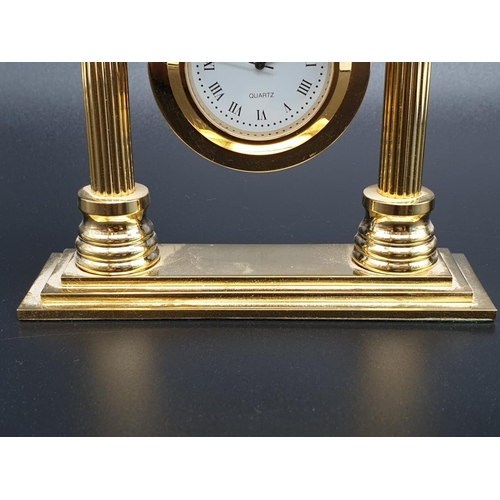 423 - A Bueche-Girod marked Gold-Tone Temple-Style Clock.
As found, 10x 10cm