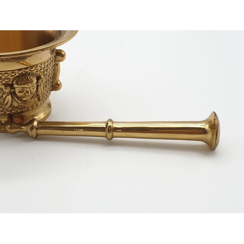 520 - A very ornate, Asian, brass, mortar and pestle. Weight: 868g.