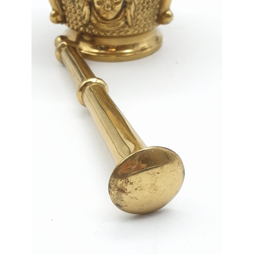 520 - A very ornate, Asian, brass, mortar and pestle. Weight: 868g.