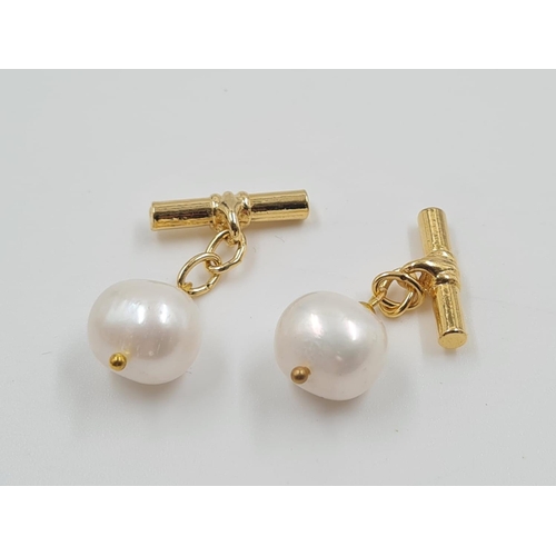 897 - A Pair of Pearl Cufflinks. Gilded metal attachments.