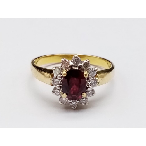 141 - 18k yellow gold ring with ruby centre and diamonds surround, weight 3.5g and size O