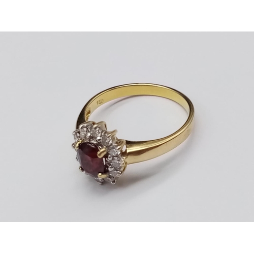 141 - 18k yellow gold ring with ruby centre and diamonds surround, weight 3.5g and size O