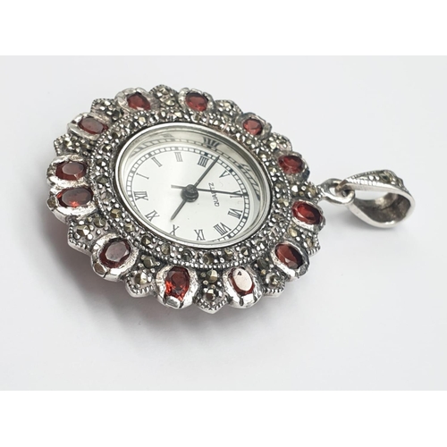 683 - Quartz clock pendant set it garnet and silver, weight 17.9g and 5cm drop approx