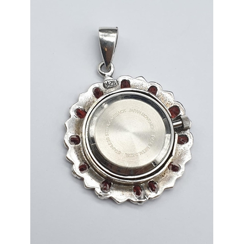 683 - Quartz clock pendant set it garnet and silver, weight 17.9g and 5cm drop approx