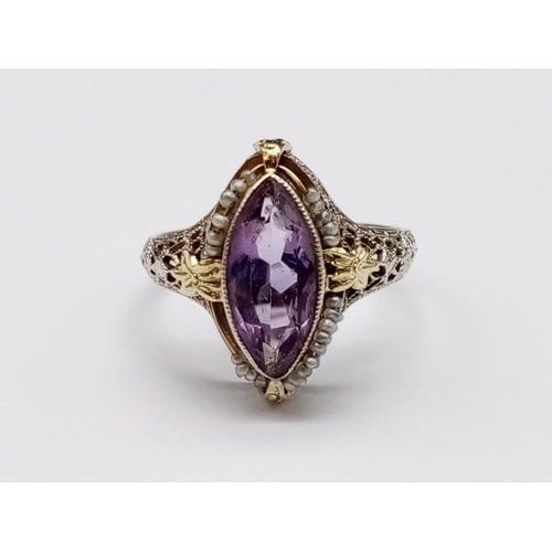 134 - Vintage 14k yellow gold ring with boat shaped amethyst centre and seed pearl decoration with filigre... 