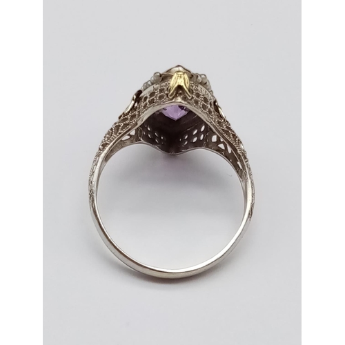 134 - Vintage 14k yellow gold ring with boat shaped amethyst centre and seed pearl decoration with filigre... 