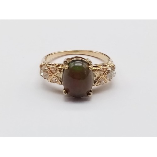 180 - Vintage Yellow gold ring with black opal centre and diamonds set on shoulders, weight 4.3g and size