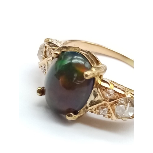 180 - Vintage Yellow gold ring with black opal centre and diamonds set on shoulders, weight 4.3g and size