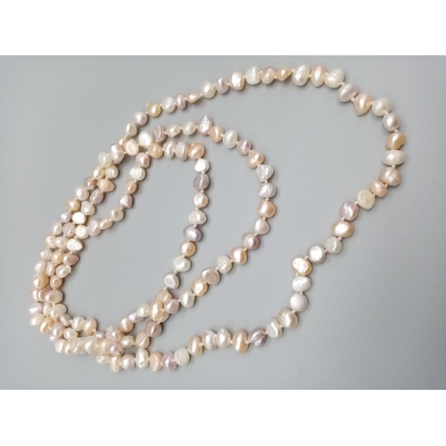 545 - A very long Natural baroque pearl chain with various shapes and shades 112cm long