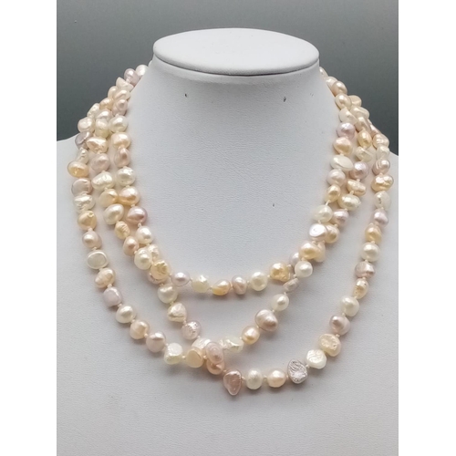 545 - A very long Natural baroque pearl chain with various shapes and shades 112cm long