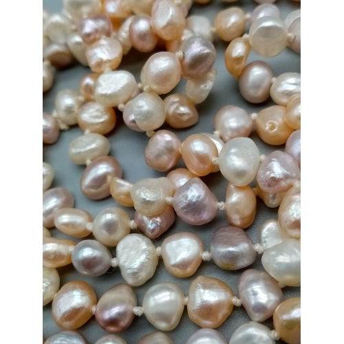 545 - A very long Natural baroque pearl chain with various shapes and shades 112cm long