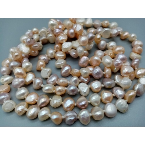 545 - A very long Natural baroque pearl chain with various shapes and shades 112cm long