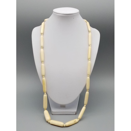 752 - A long vintage ivory necklace 64cm long approx