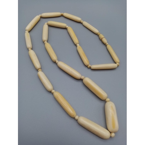 752 - A long vintage ivory necklace 64cm long approx