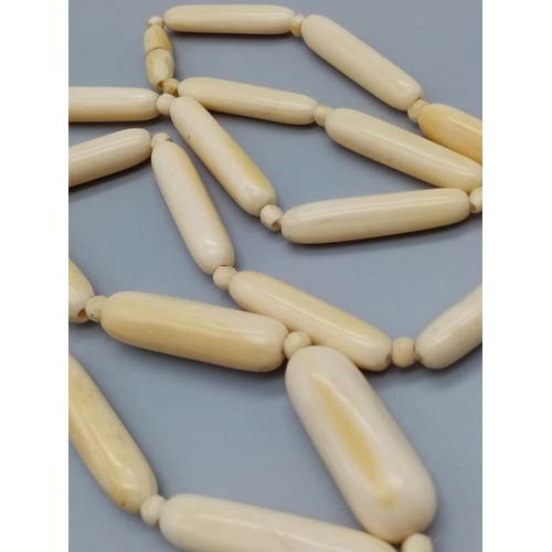 752 - A long vintage ivory necklace 64cm long approx