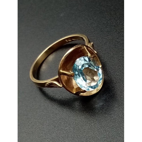 328 - 9k yellow gold ring with large blue stone setting, weight 4.8g and size Q