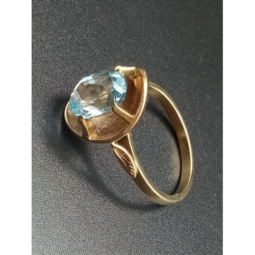 328 - 9k yellow gold ring with large blue stone setting, weight 4.8g and size Q