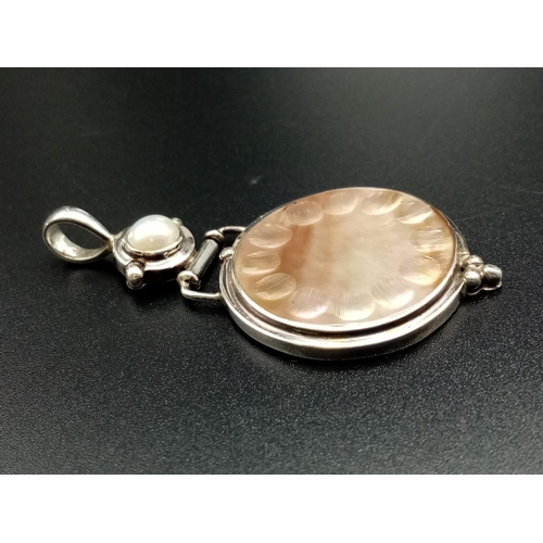 581 - Mother of pearl and silver pendant, weight 10g and 6.5cm drop approx