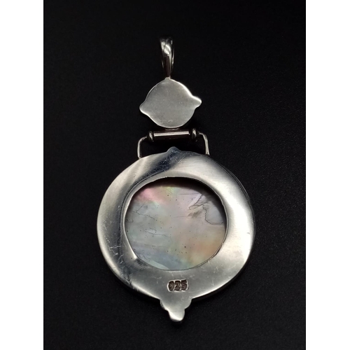 581 - Mother of pearl and silver pendant, weight 10g and 6.5cm drop approx