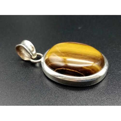 587 - Tiger's eye silver pendant weight 8.9g and 4cm drop approx