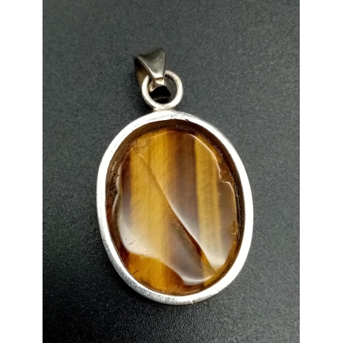 587 - Tiger's eye silver pendant weight 8.9g and 4cm drop approx