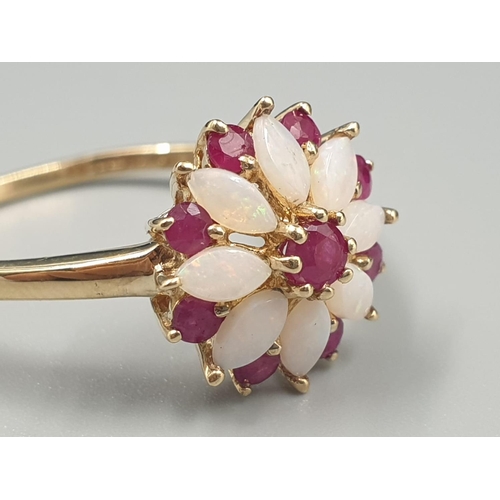 109 - 9K YELLOW GOLD VINTAGE OPAL AND RUBY CLUSTER RING FLOWER DESIGN, WEIGHT 2.2G SIZE U