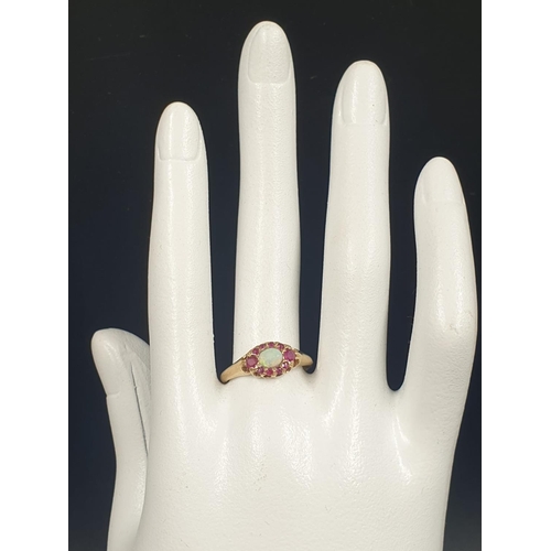 137 - 9K YELLOW GOLD VINTAGE OPAL CENTRE & RUBY SURROUNDS CLUSTER RING WEIGHT 2.2G SIZE O