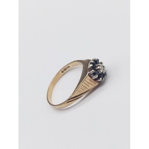 321 - 9k yellow gold diamond and sapphire ring floral design, weight 2.1g and size L1/2