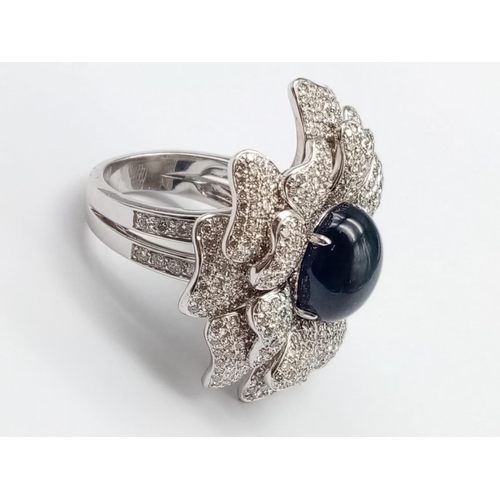 44 - an 18k white gold ring with a large saphire centre stone surrounded by individual diamond encrusted ... 