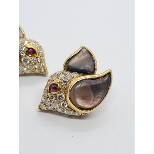 310 - A PAIR OF 18K DIAMOND EARRINGS SHAPED LIKE FLYING BIRDS WITH BLACK PEARL WINGS AND RUBY EYES.  8.3gm... 