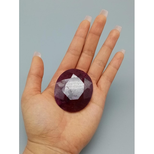 593 - A large 295ct natural ruby gemstone, oval cut, with GLI certification