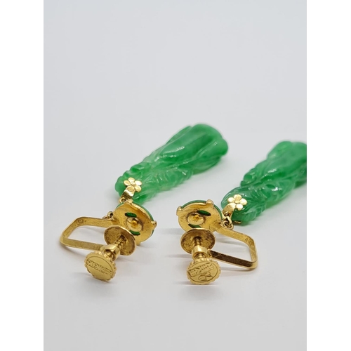 80 - Pair of 21k yellow Oriental gold earrings with natural carved Jade, weight 6.16g and 4cm drop approx