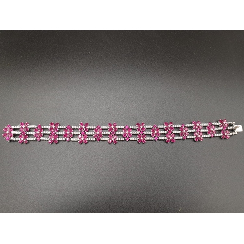 303 - AN EXTREMELY ATTRACTIVE 3 ROW 18K WHITE GOLD BRACELET WITH ENCRUSTED DIAMONDS AND DECORATED WITH  A ... 