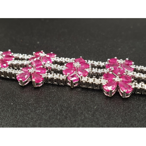 303 - AN EXTREMELY ATTRACTIVE 3 ROW 18K WHITE GOLD BRACELET WITH ENCRUSTED DIAMONDS AND DECORATED WITH  A ... 