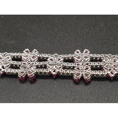 303 - AN EXTREMELY ATTRACTIVE 3 ROW 18K WHITE GOLD BRACELET WITH ENCRUSTED DIAMONDS AND DECORATED WITH  A ... 