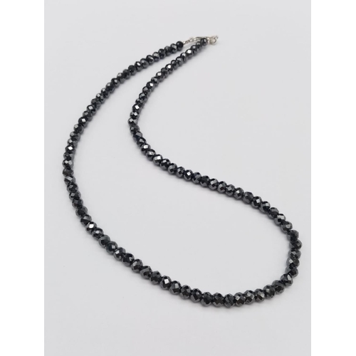 568 - A 125ct black moissanite gemstone necklace (approx 5.5mm beads) in silver clasp length 18