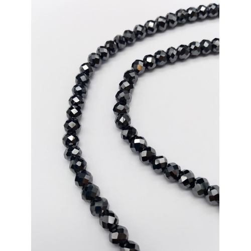 568 - A 125ct black moissanite gemstone necklace (approx 5.5mm beads) in silver clasp length 18