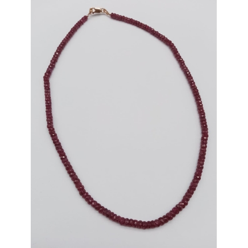 575 - A 120ct ruby gemstone necklace, gilt clasp length 18