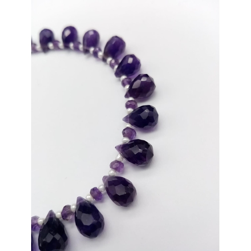 600 - An amethyst drops necklace, with alternate seed pearl, length 18