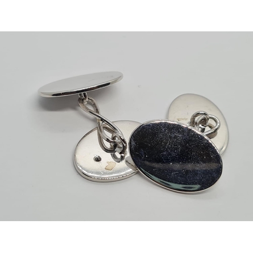 700 - a pair of 18k white gold cuff links with a set diamond .
15.7gms