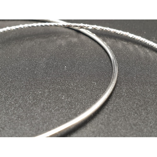 284 - STERLING SILVER DOUBLE BANGLE WITH 3 CHARMS WEIGHT 9.3G AND 7.5CM DIAMETER