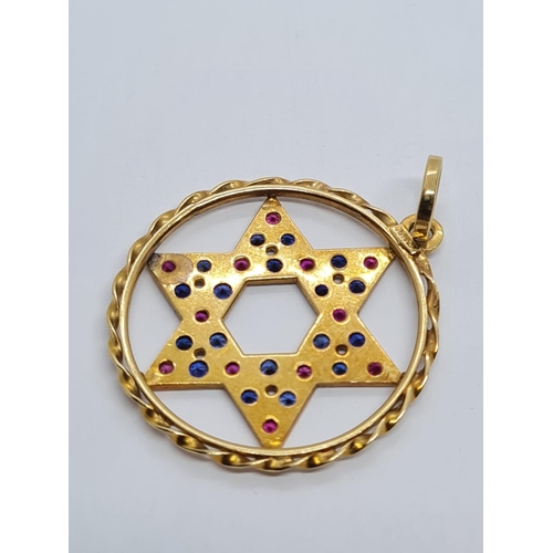 401 - 18k Yellow Gold Ruby and Sapphire Star of David Pendant. 15 Rubies and 15 Sapphires complete this wo... 