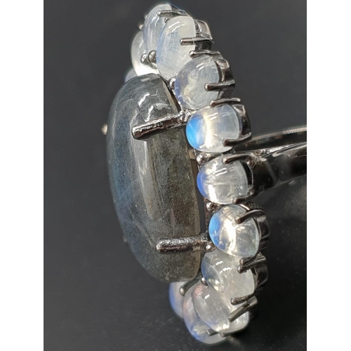 914 - 10.50 Ct Moonstones & 14.25 Ct Labradorite set within a blackened silver ring, weight 11.62g and siz... 