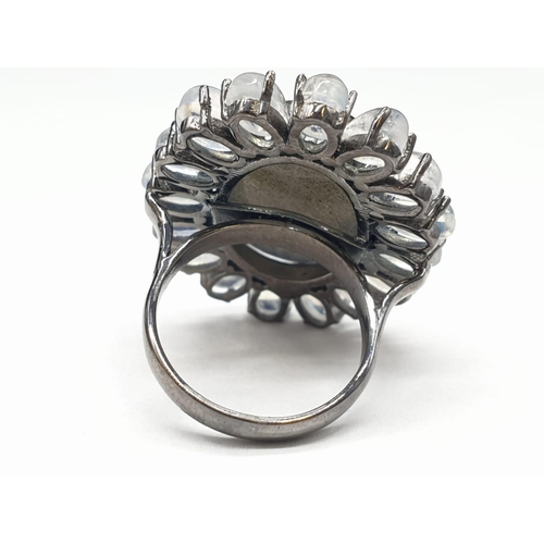 914 - 10.50 Ct Moonstones & 14.25 Ct Labradorite set within a blackened silver ring, weight 11.62g and siz... 