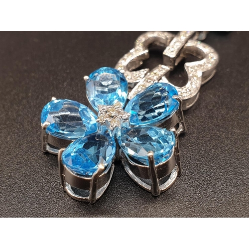 306 - AN 18K WHITE GOLD NECKLACE WITH DIAMOND, ACQUA MARINE AND TOPAZ STONES FASHIONED INTO A FLORAL DESIG... 